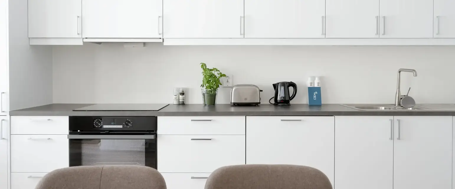 a kitchen with white cabinets and a table