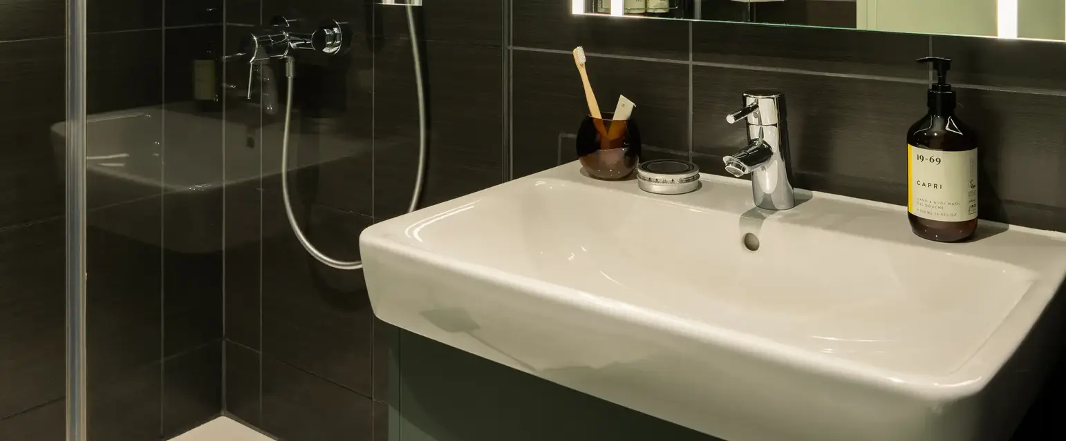 a bathroom with a mirror and a sink