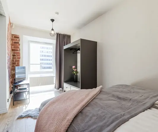 a bedroom with a bed and a tv