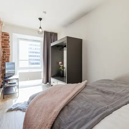 a bedroom with a bed and a tv