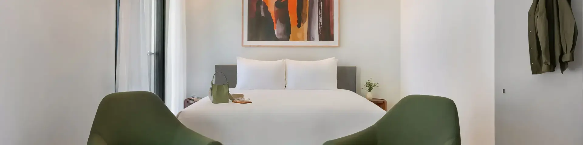 a room with a bed and chairs