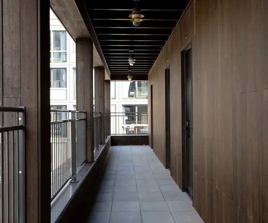 a hallway with a railing and doors