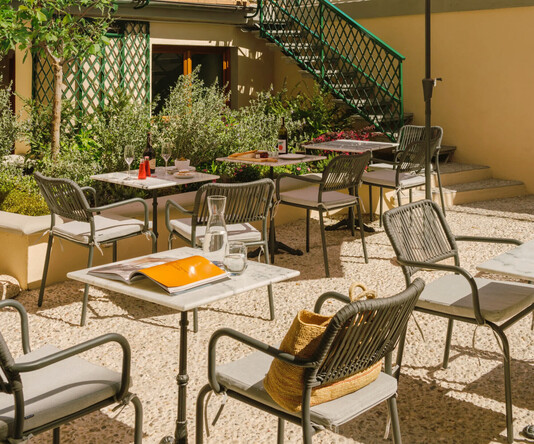 a patio with tables and umbrellas