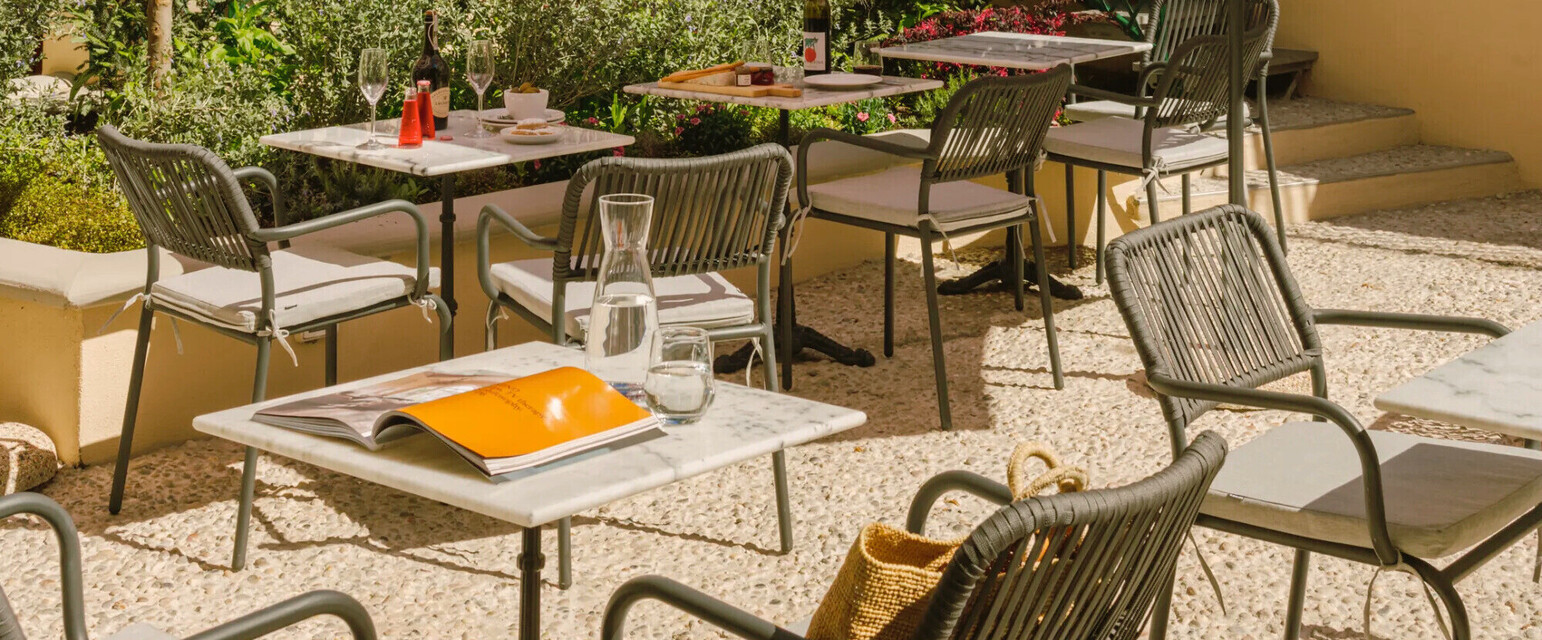 a patio with tables and umbrellas
