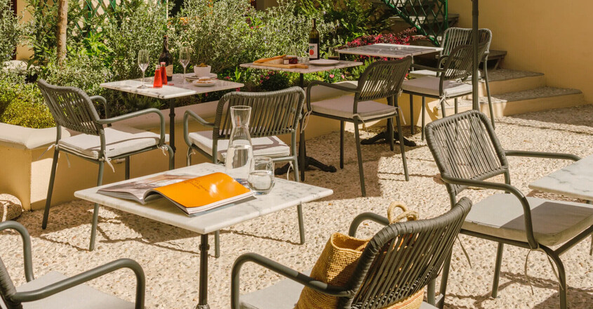 a patio with tables and umbrellas