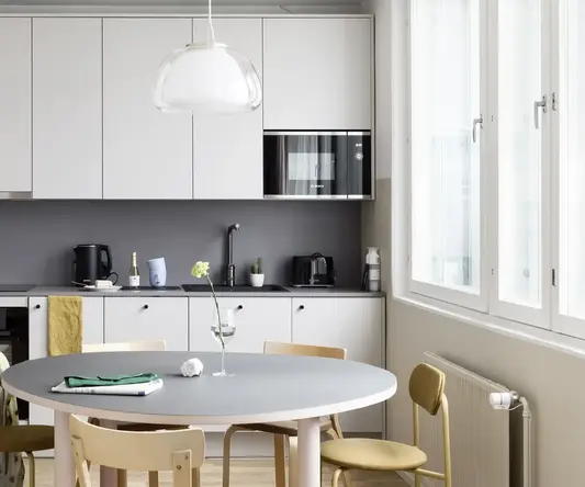 a kitchen with a table and chairs