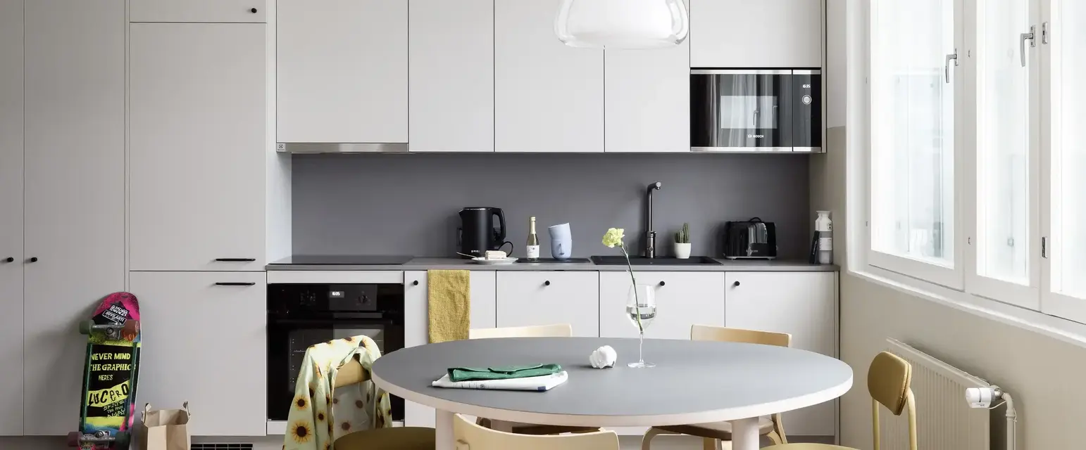 a kitchen with a table and chairs
