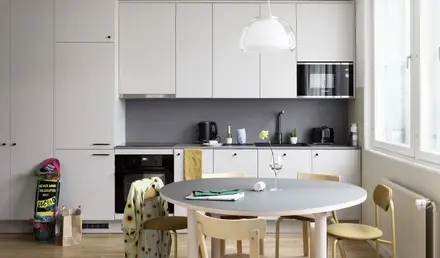 a kitchen with a table and chairs