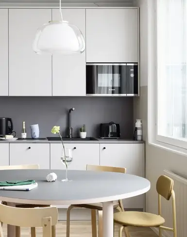 a kitchen with a table and chairs