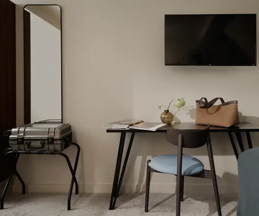 a room with a table and a television on the wall