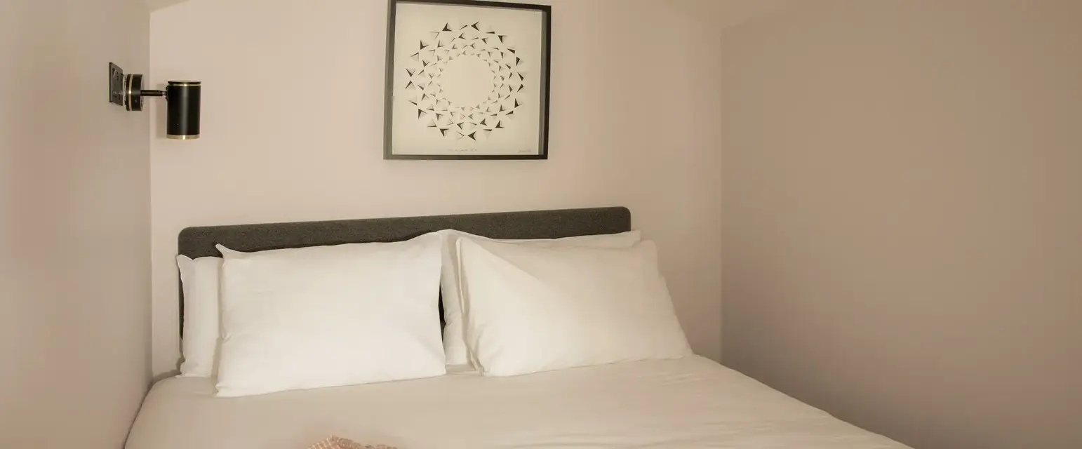 a bed with pillows and a blanket on it