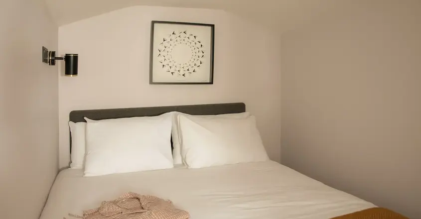 a bed with pillows and a blanket on it