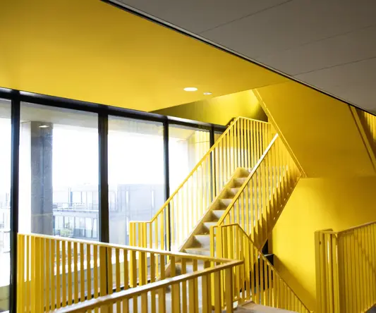 a yellow staircase in a building