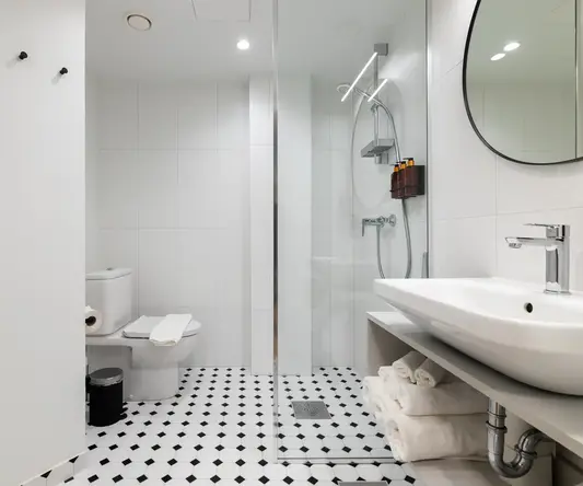 a bathroom with a glass shower door and a sink