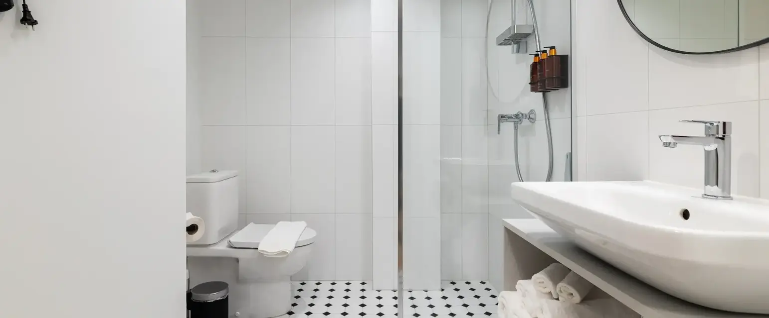 a bathroom with a glass shower door and a sink