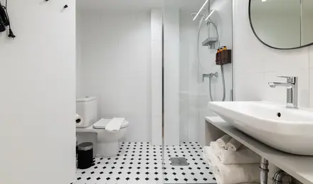 a bathroom with a glass shower door and a sink