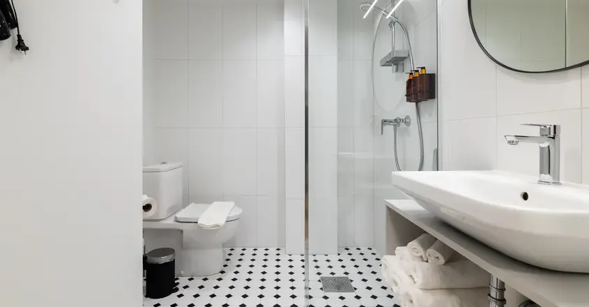 a bathroom with a glass shower door and a sink