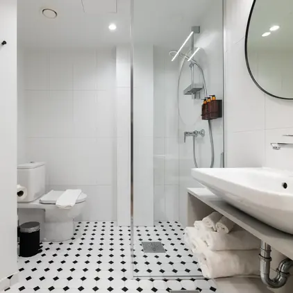 a bathroom with a glass shower door and a sink