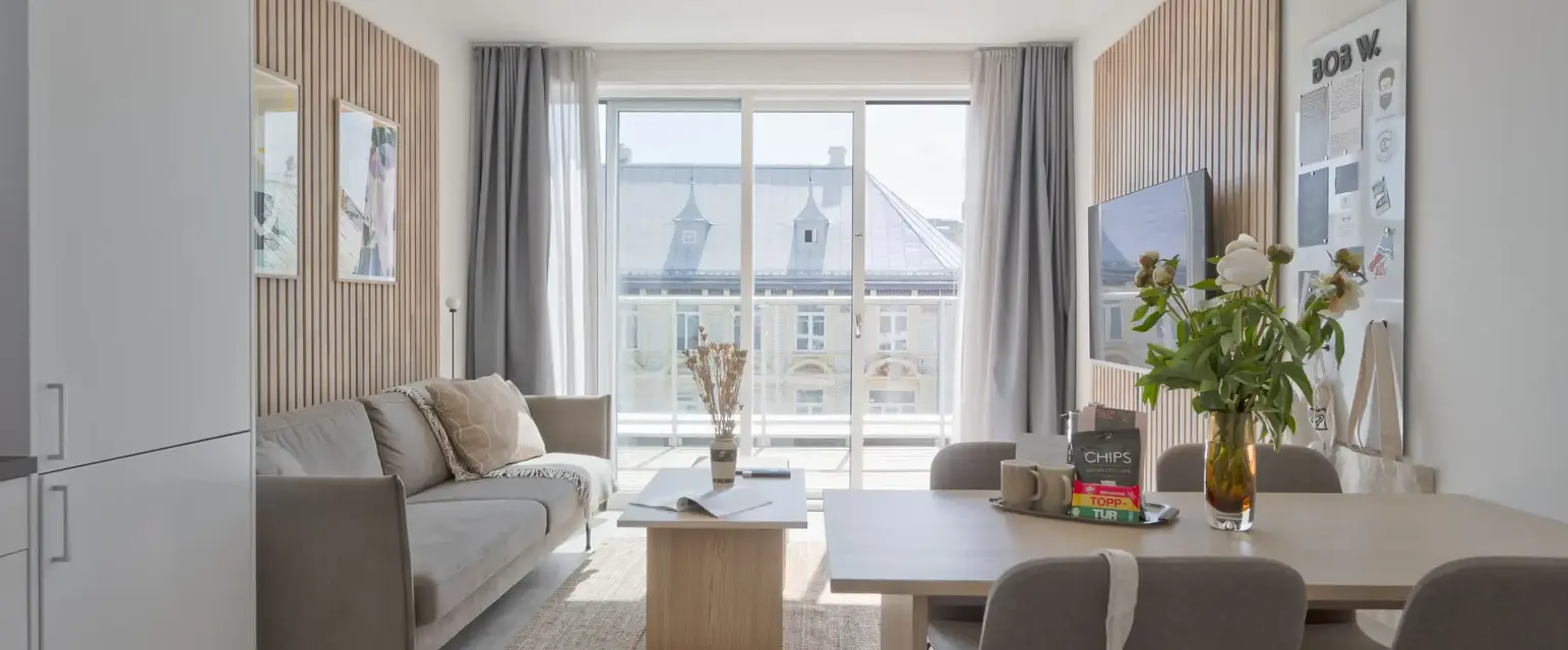 a living room with a table and chairs