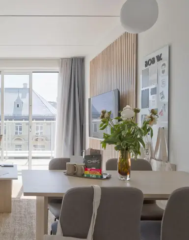 a living room with a table and chairs