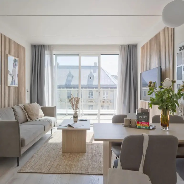 a living room with a table and chairs