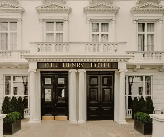 a building with columns and black doors