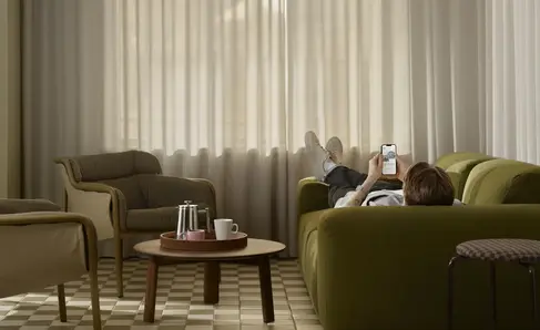 a man lying on a couch with his legs up and a coffee table