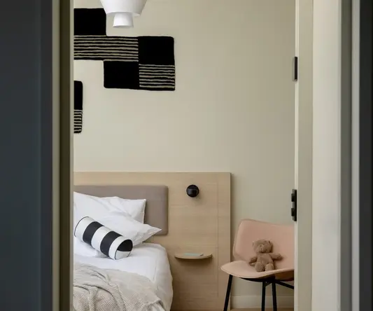 a bedroom with a bed and a chair