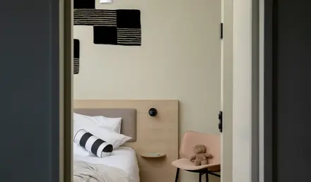 a bedroom with a bed and a chair
