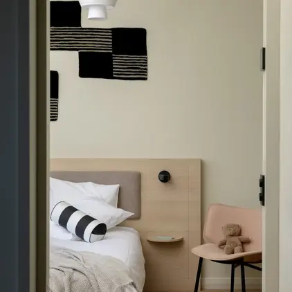 a bedroom with a bed and a chair