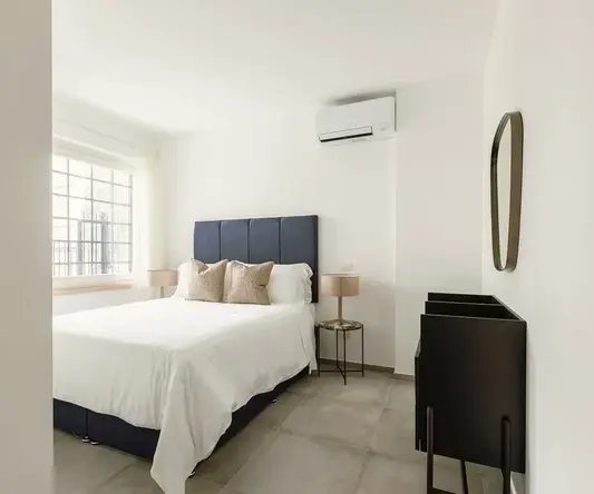 a bedroom with a bed and a mirror