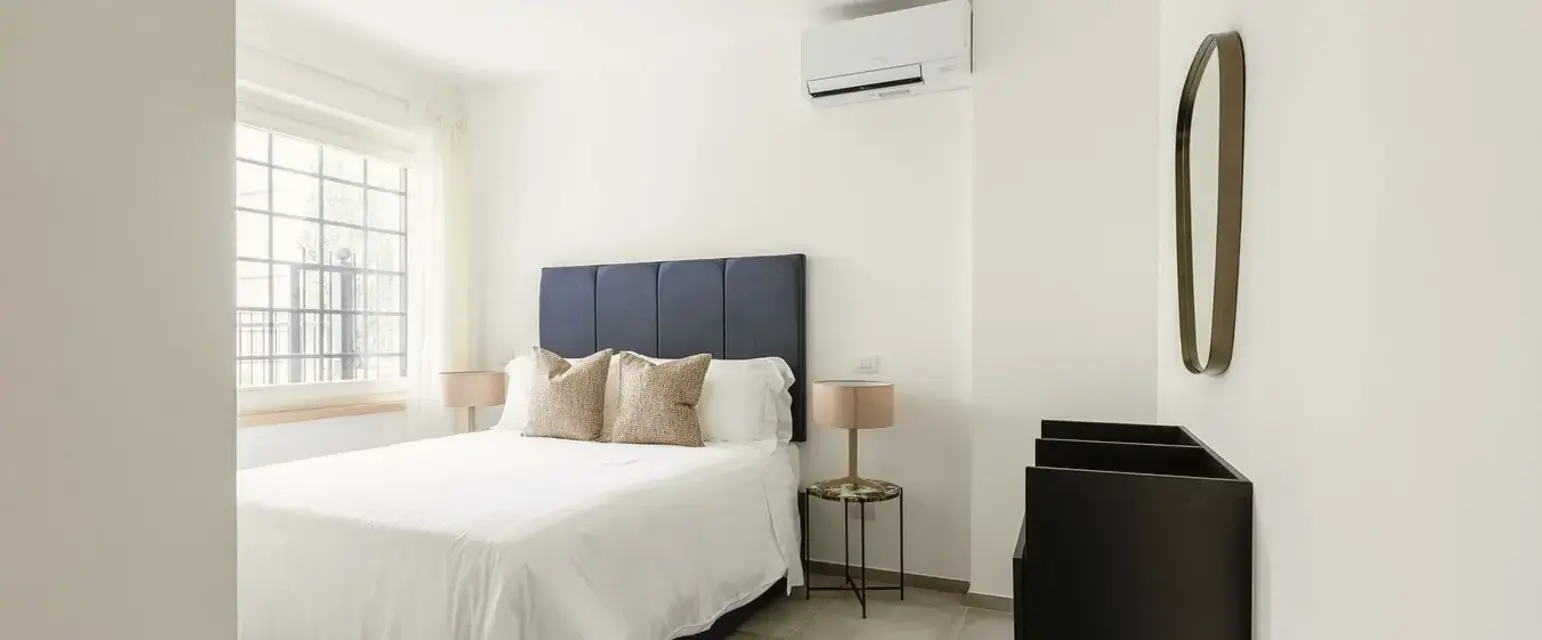 a bedroom with a bed and a mirror