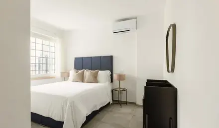 a bedroom with a bed and a mirror
