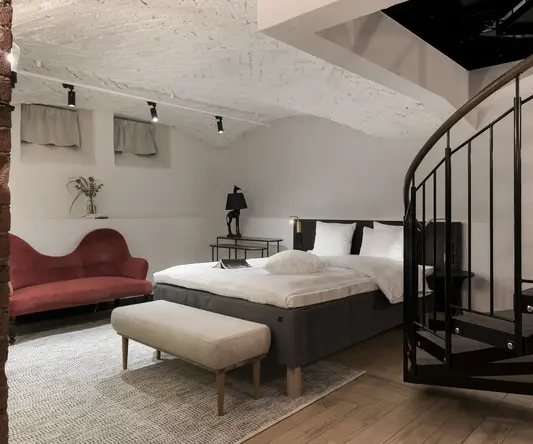 a bedroom with a spiral staircase