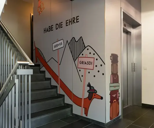 a staircase with a mural on the wall
