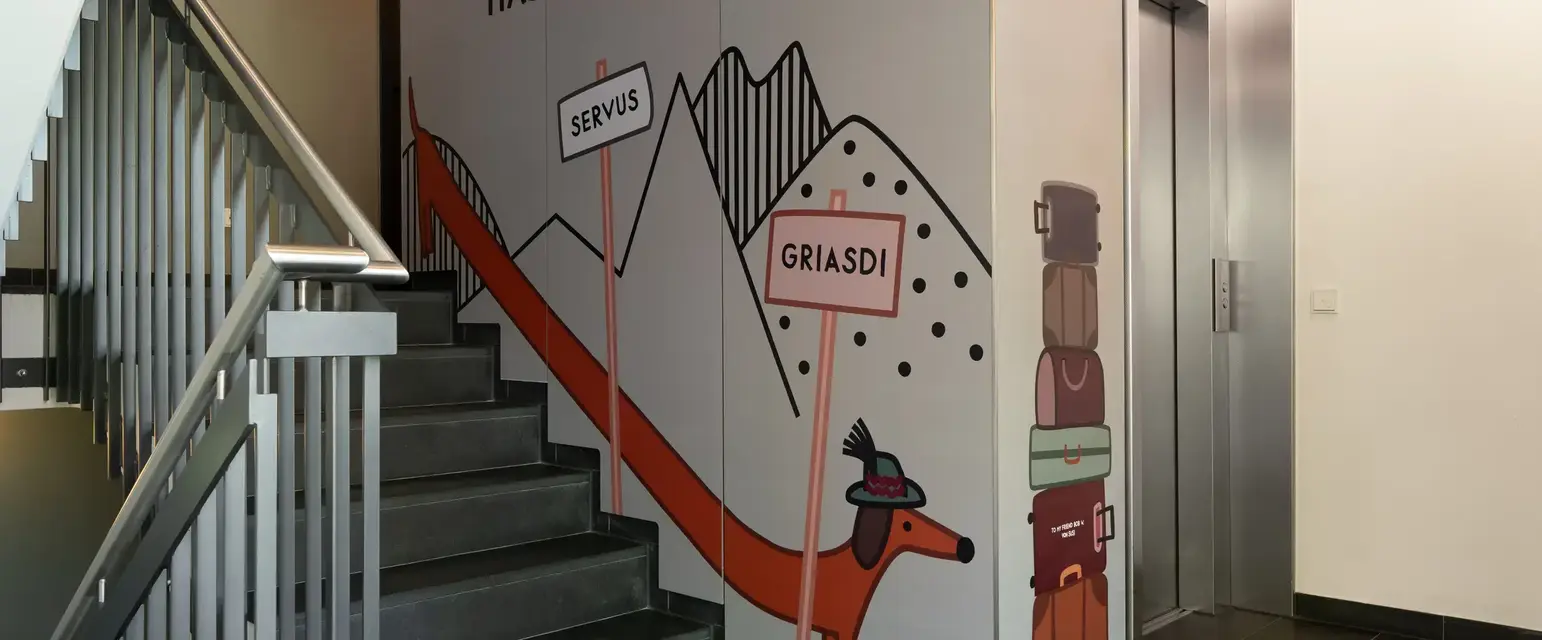 a staircase with a mural on the wall