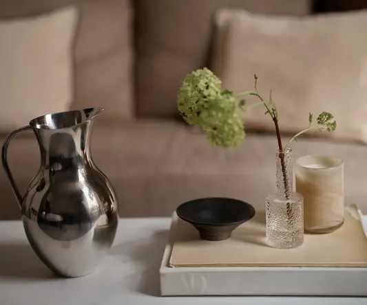 a vase and candle on a table