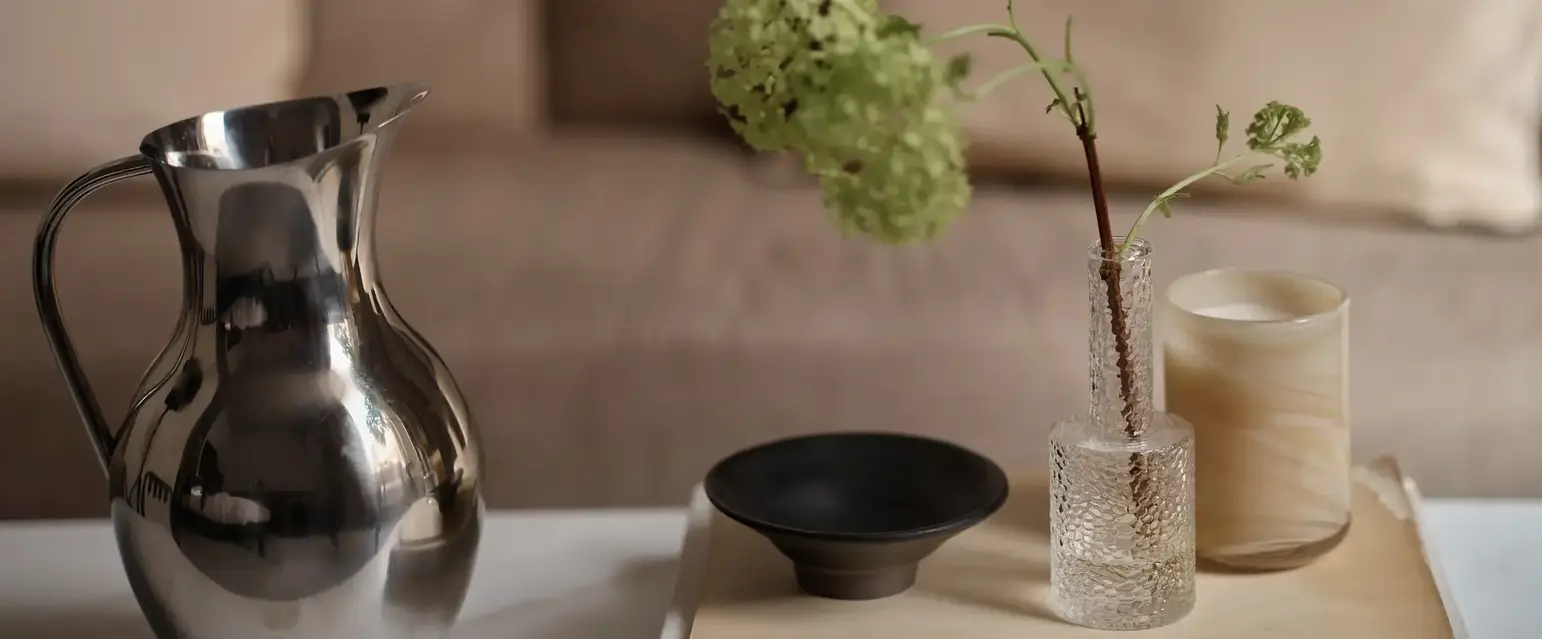 a vase and candle on a table