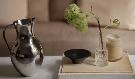 a vase and candle on a table