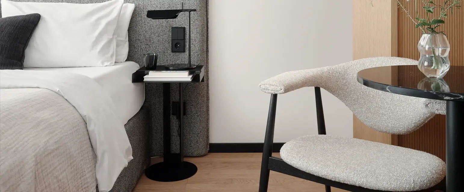 a chair next to a bed