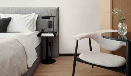 a chair next to a bed