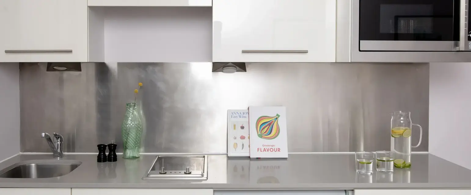 a kitchen with white cabinets and white appliances