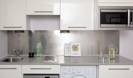 a kitchen with white cabinets and white appliances