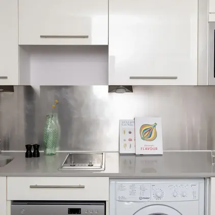 a kitchen with white cabinets and white appliances