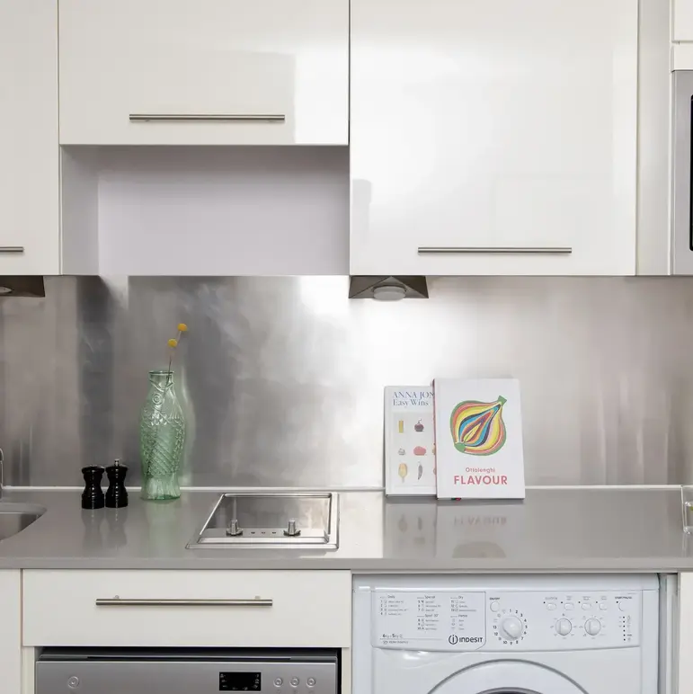a kitchen with white cabinets and white appliances