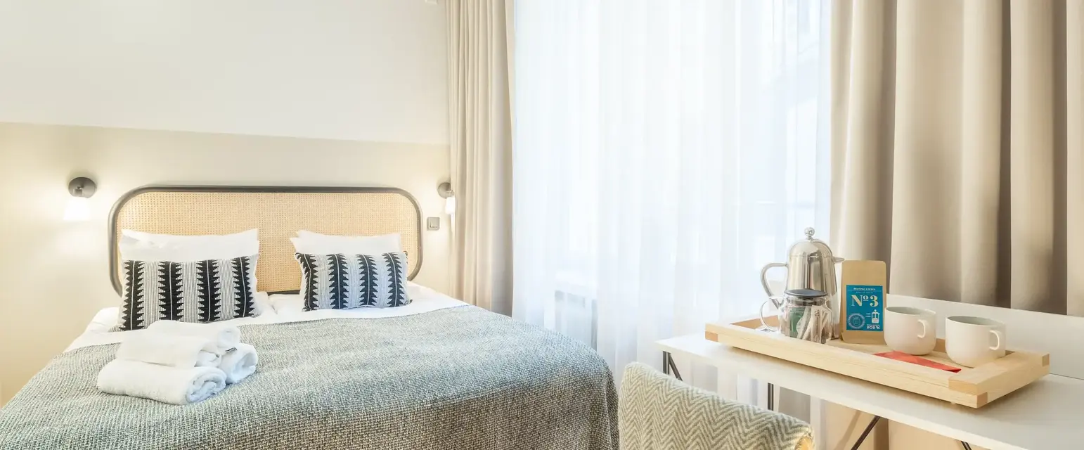 a bed with a table and a coffee pot