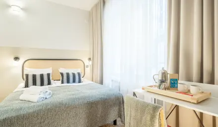 a bed with a table and a coffee pot