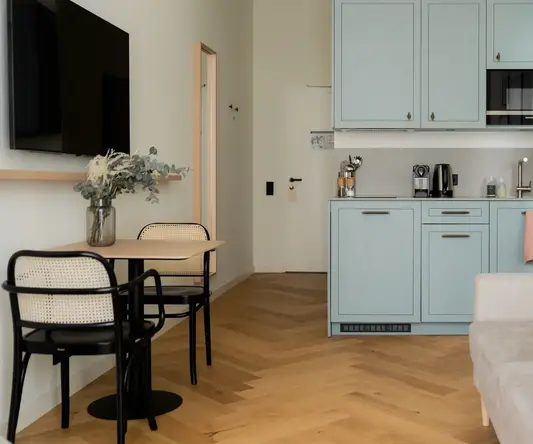 a kitchen with a couch and a table