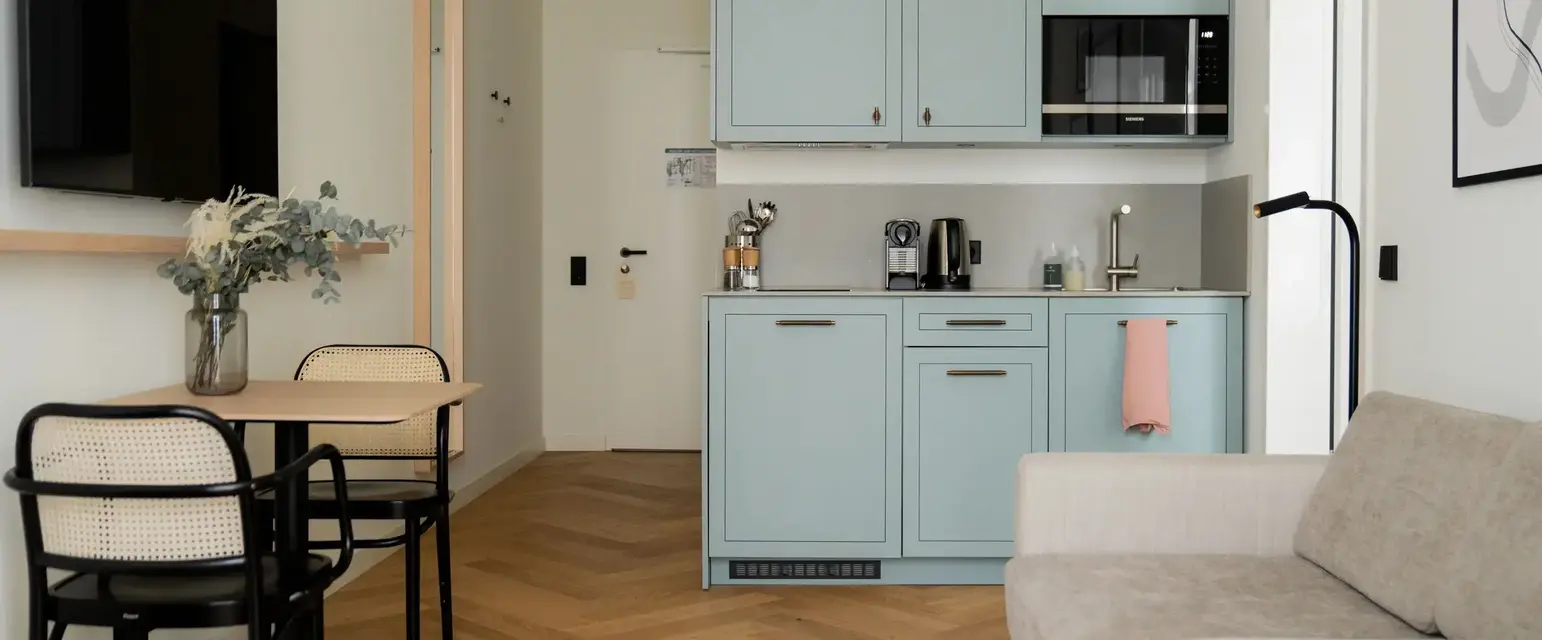 a kitchen with a couch and a table