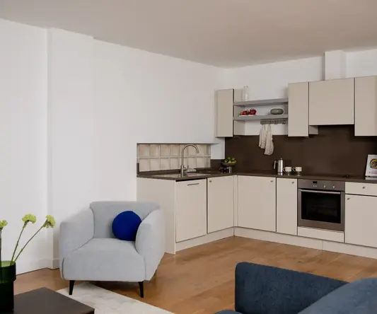 a living room with a couch and kitchen